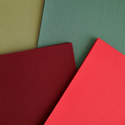 Four overlapping rectangular sheets from the Holiday Fabric Card Layers set—featuring olive green, forest green, burgundy, and red—are arranged in a slightly angled composition, perfect for adding a festive touch to your Christmas card projects.