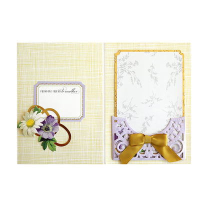 A mini album card adorned with an elegant bow and delicate flowers, created using the Anniversary Pocket Dies.