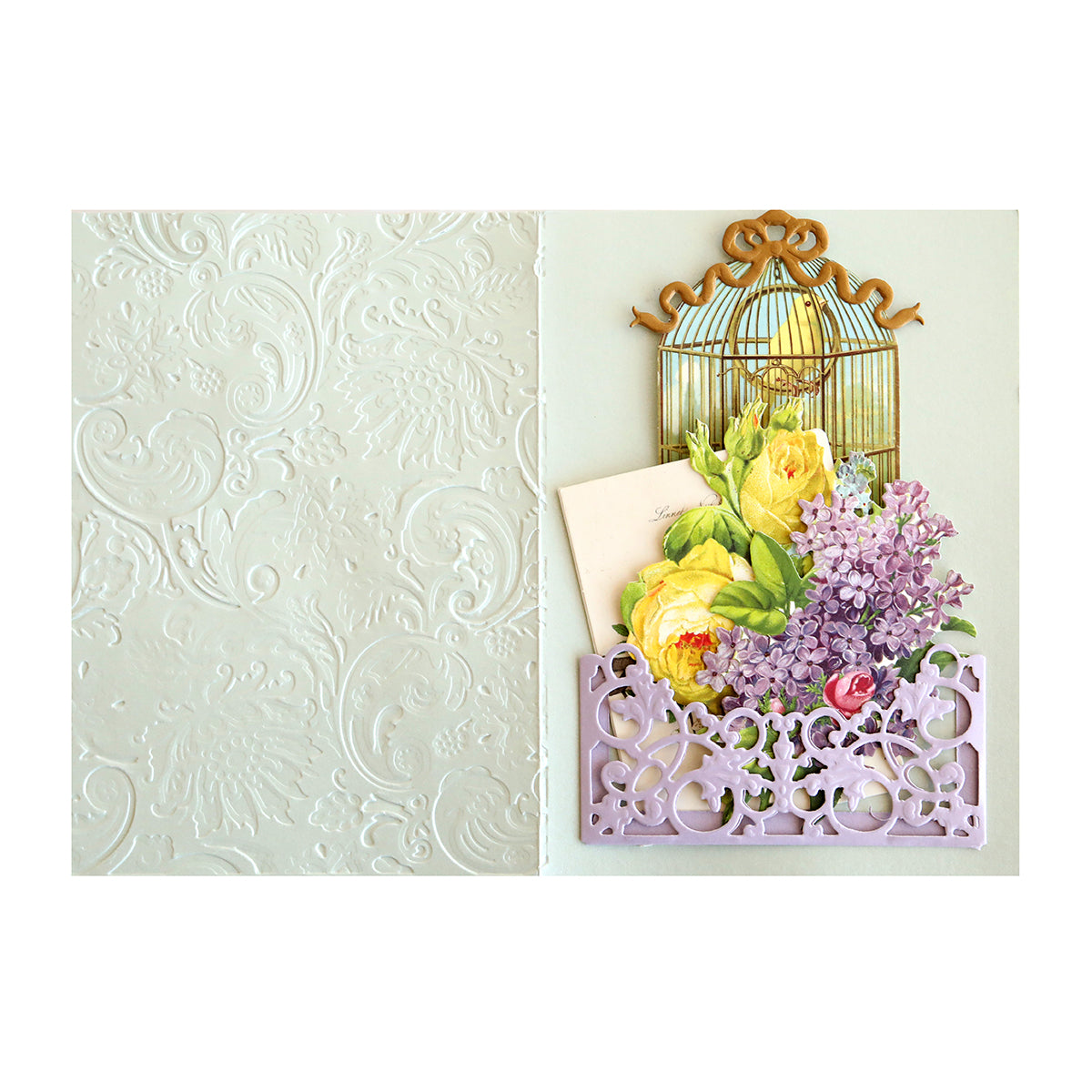 An elegant card featuring a delicate birdcage and beautiful flowers, created using the Anniversary Pocket Dies. This stunning design is perfect for creating mini album cards that will be cherished for