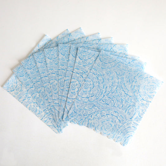 The Blue Vellum Wrap 10 pack features ten blue patterned paper napkins displayed in a fan shape on a white background.