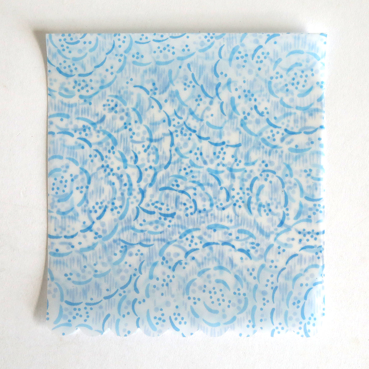 The Blue Vellum Wrap 10 pack features square translucent sheets with a light blue floral and dotted pattern on white, ideal for elegant wedding invitation wraps.