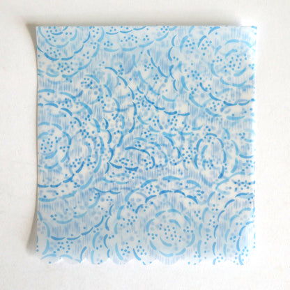 The Blue Vellum Wrap 10 pack features square translucent sheets with a light blue floral and dotted pattern on white, ideal for elegant wedding invitation wraps.
