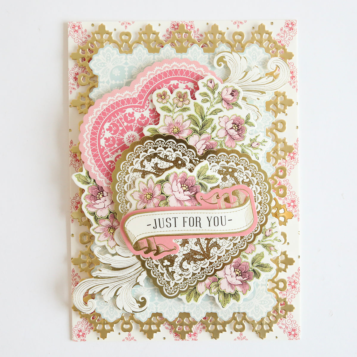 A vintage Valentine's card adorned with delicate pink flowers and Lace Doily Embellishments for added dimension and texture.