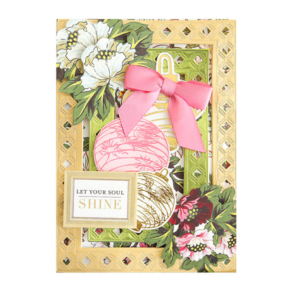 A decorative handmade card made with Crop at Home 5 Frame Dies features floral patterns, a pink bow, round ornaments, and a gold-bordered message that says "Let your soul shine.
