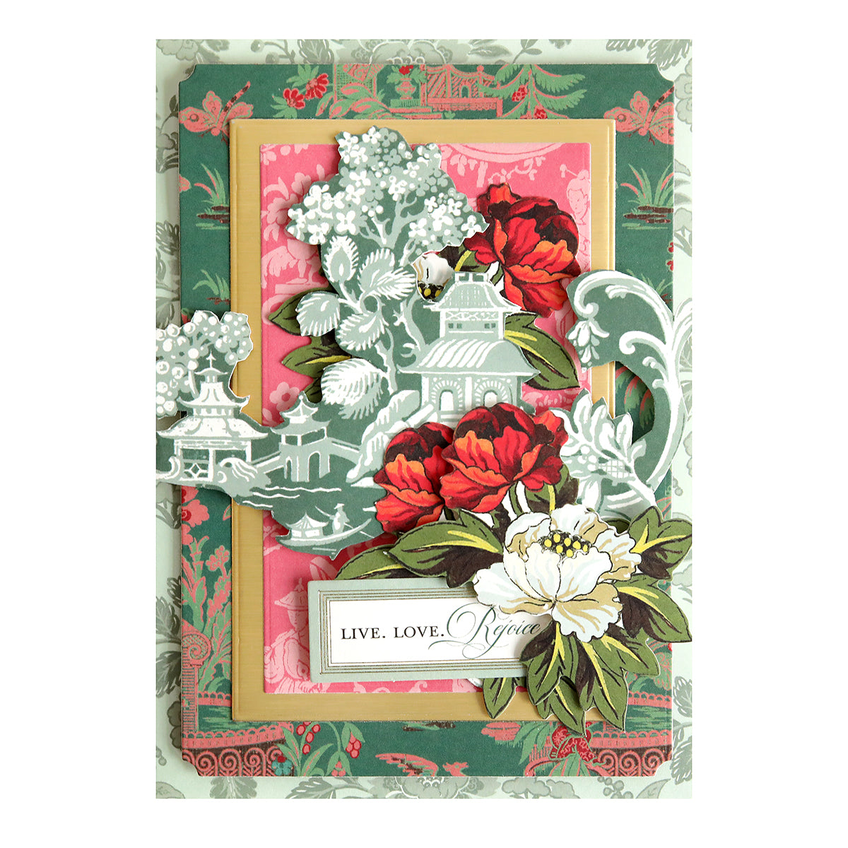 Layered papercraft card from the Lian Ultimate Papercrafting Collection with Rub On Transfers featuring a pagoda, red and white flowers, and a label reading “LIVE. LOVE. REJOICE.”