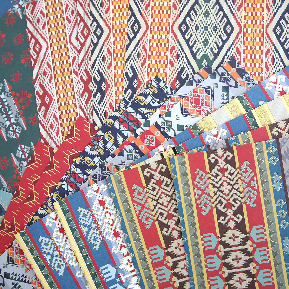 A pile of Lomasi Cardstock Collection papers with different designs on them.