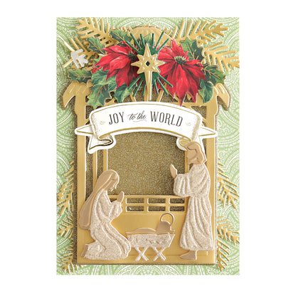 A decorative Christmas card on Luxury Glitter Cardstock, featuring Mary, Joseph, and baby Jesus in the nativity scene with poinsettias, gold accents, and a "Joy to the World" banner. Ideal for your scrapbook supplies collection.