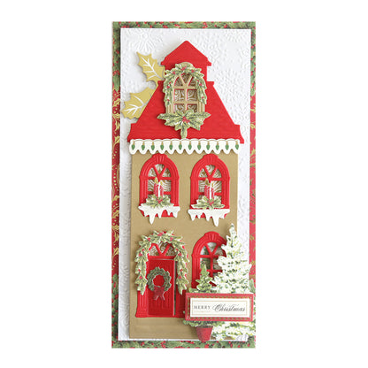 A vertical holiday card showcasing a red and beige house with a white snow-covered roof, decorated with wreaths and greenery, all crafted on Luxury Shimmer Cardstock - Holiday, featuring "Merry Christmas" elegantly written on the lower right.