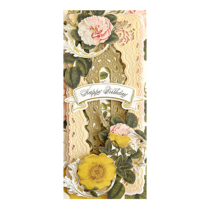 A floral birthday card crafted with Antique Luxury Shimmer Cardstock, highlighting intricate lace details and embossed pink and yellow flowers that frame "Happy Birthday" on a gold and cream background. Its elegance is enhanced by delicate die-cut touches.