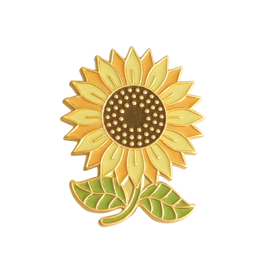 A radiant accessory from the 2026 Exclusive Pins collection, the Members Only September 2026 Pin features a gold and yellow enamel sunflower with a brown center and two green leaves, shown against a plain white background.