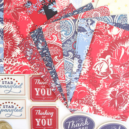 The Madison Paper Crafting Collection offers a vibrant assortment of vintage-inspired red, white, and blue patterned papers and stickers. Perfect for adding patriotic embellishments to your projects.