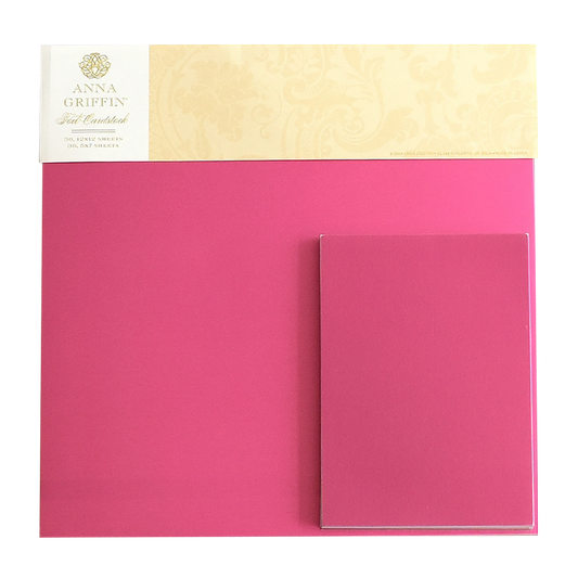A pack of Foil Matte Cardstock - Raspberry, featuring 250gsm 12x12 bright pink foil sheets with a matching pink notecard placed on top.