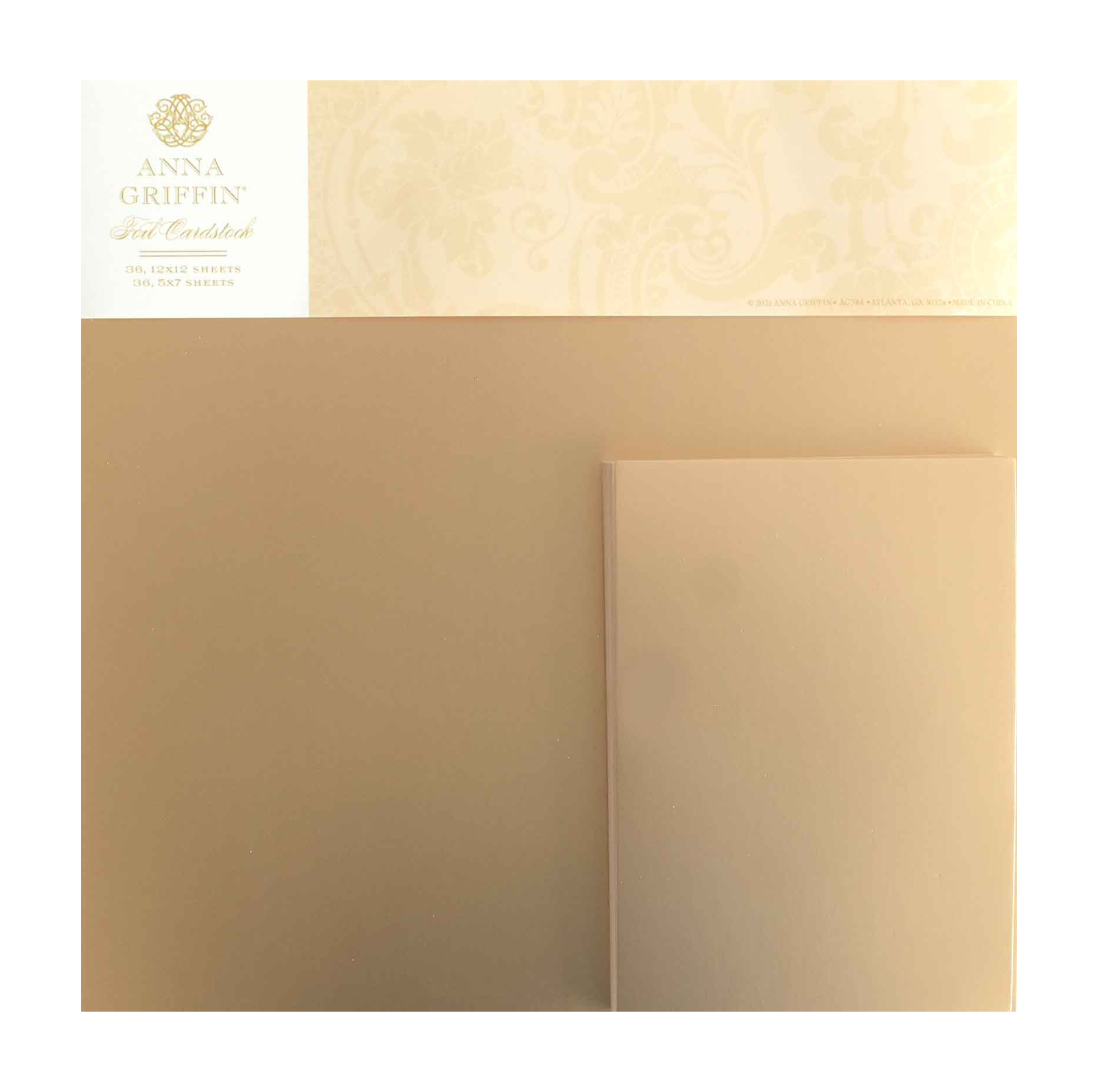 A package of Foil Matte Cardstock - Rose Gold by Anna Griffin, made from premium 250gsm cardstock with the brand name and logo in the upper left corner.