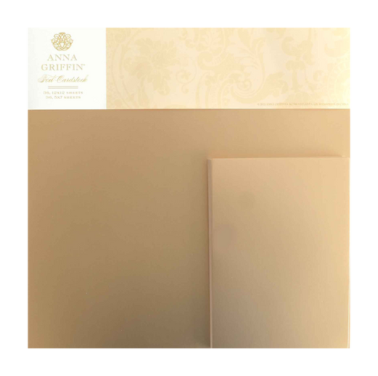 A package of Foil Matte Cardstock - Rose Gold by Anna Griffin, made from premium 250gsm cardstock with the brand name and logo in the upper left corner.