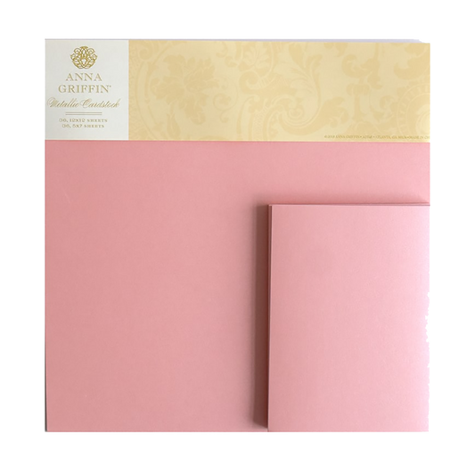 A bundle of Metallic Cardstock in Pearl Pink, 12x12 sheets, with a matching folded card displayed against a white background.