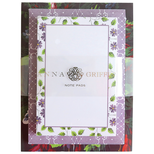 A decorative Astrid Note Pad Set package with 300 sheets on a floral background.