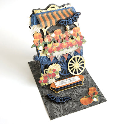 A vibrant pop up card featuring a stunning flower cart, intricately crafted using diecutting techniques. Made with exquisite Anna Griffin Navy Metallic cardstock, this card is perfect for all your card making needs.