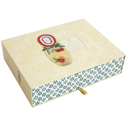 The Paper Elf Shoe Finishing School Craft Box is a decorative, beige craft box with a festive design. It features a gold patterned lid adorned with holly and a red seal, along with a lower portion that boasts a green and white pattern reminiscent of elf shoes. Additionally, it has an attached gold ribbon tab.