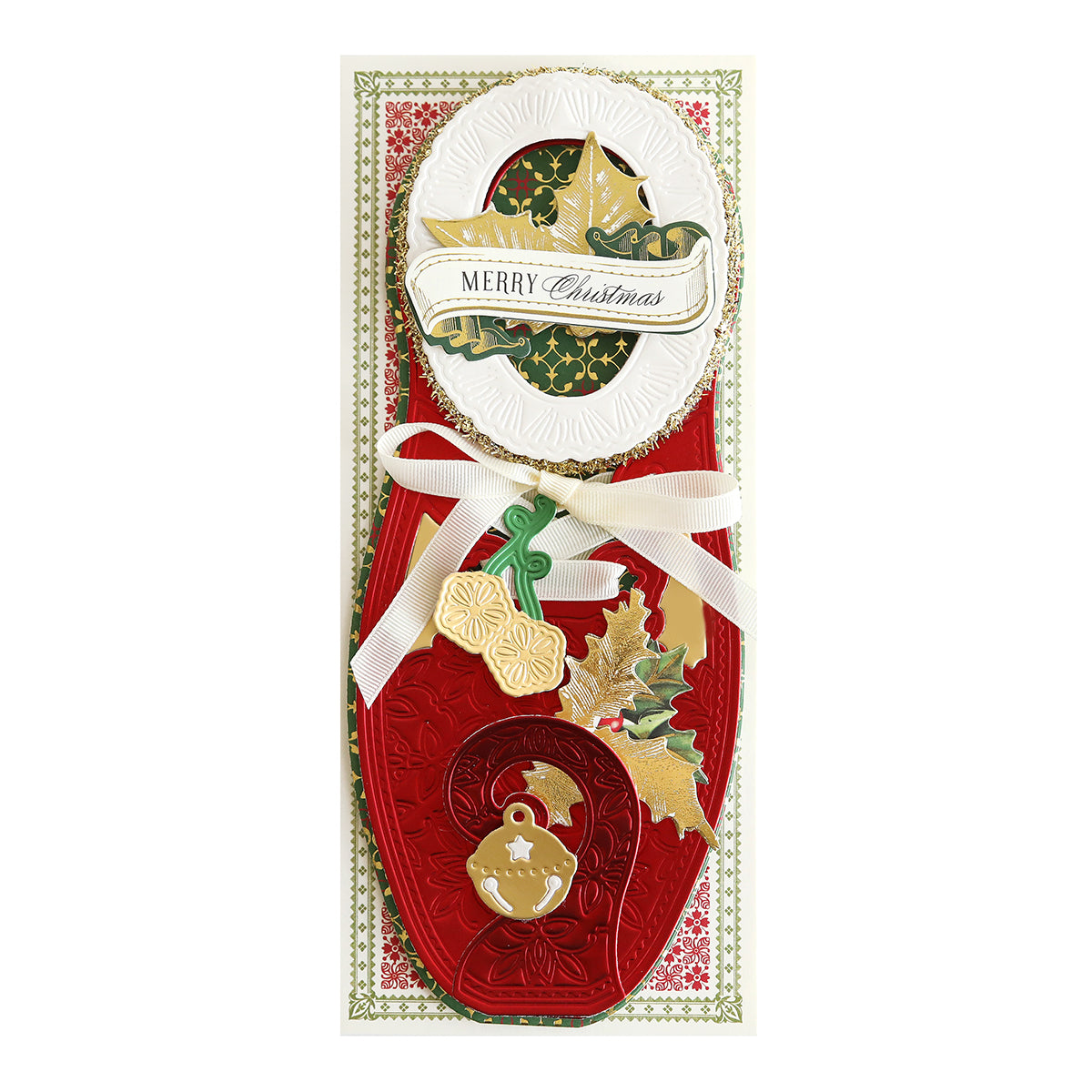 A delightful Paper Elf Shoe Finishing School Craft Box card featuring red, gold, and green hues with embossed patterns, a white ribbon, and a "Merry Christmas" message. Small festive ornaments and leaves are attached to the card, reminiscent of whimsical handcrafted creations.