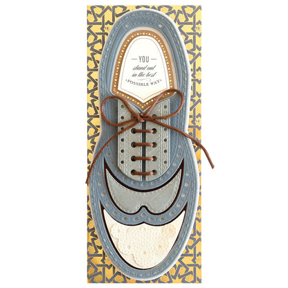 Greeting card designed as a blue and brown shoe with text inside that reads "You stand out in the best possible way," encased in a decorative patterned border from Paper Wingtips Finishing School Craft Box.