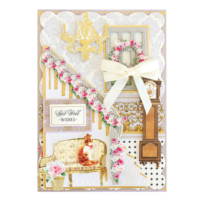 A layered paper craft greeting card featuring a staircase with floral garlands, a cat on a settee, a grandfather clock, a Perfect Double Bows 50 count, and the text “Get Well -WISHES-.”