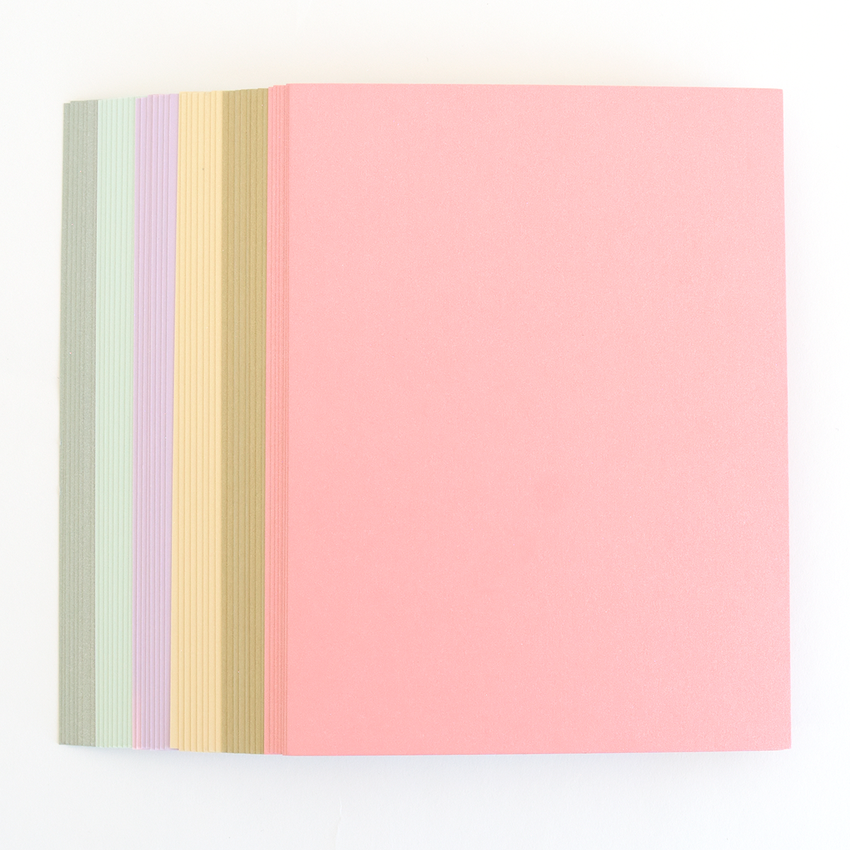 Six Perfect Palette Flocked and Printed Cardstock folders stacked together in pastel shades, with the top one pink and edges of green, lavender, yellow, and beige visible—perfect for cardmaking.