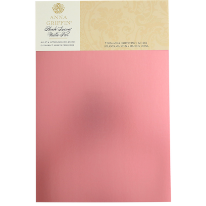 A package of Phoebe Luxury Matte Foil Cardstock 8x12 in pink, perfect for luxurious crafting projects, featuring the product's branding and details on the top part of the packaging.