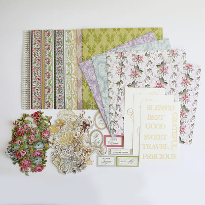 An assortment of decorative 12" x 12" papers, floral embellishments, and phrase cutouts arranged on a flat surface offers the perfect selection of Phoebe Papers and Embellishments for your crafting projects.