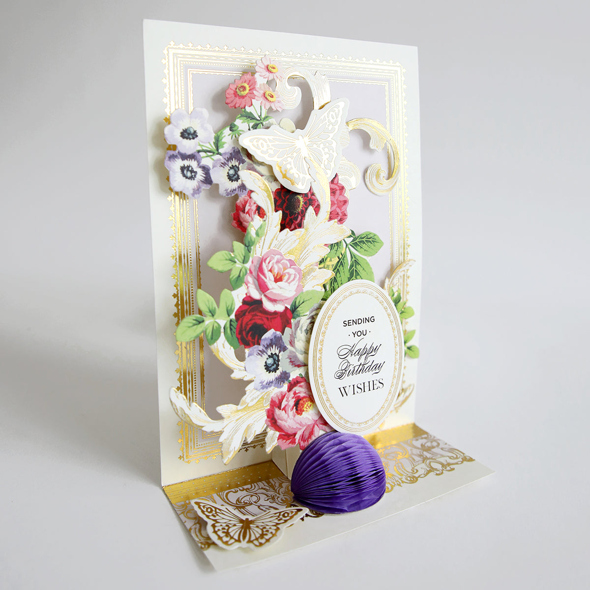 An Anna Griffin vintage inspired Pulley Honeycomb card with flowers and a ribbon on it.
