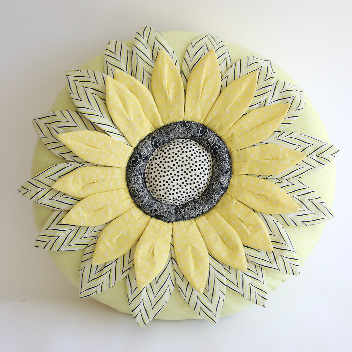 A whimsical Sunflower Pillow Pattern on a white surface.