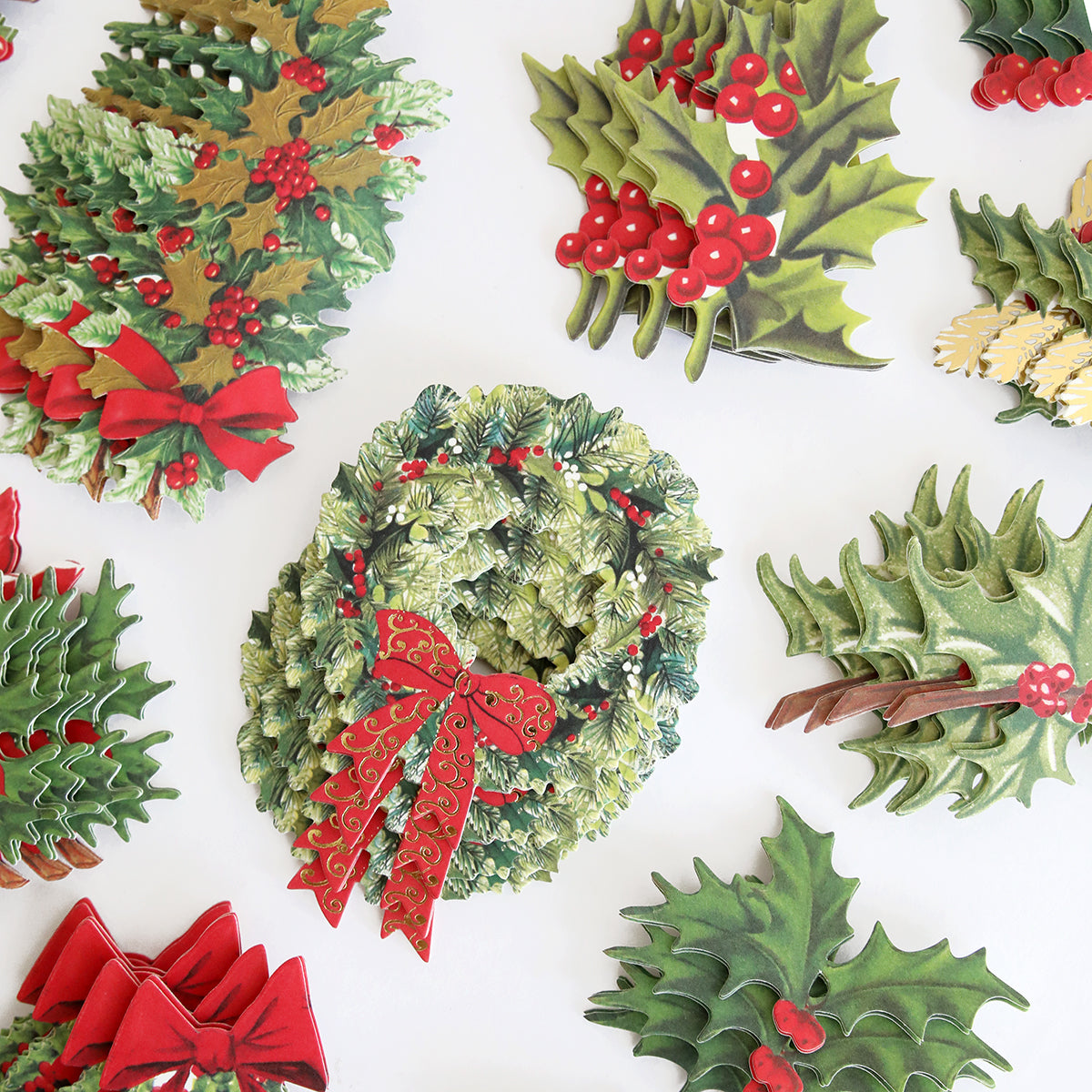 A collection of Retro Holly Sticker Library adorned with holly leaves, bows, and 3D stickers.