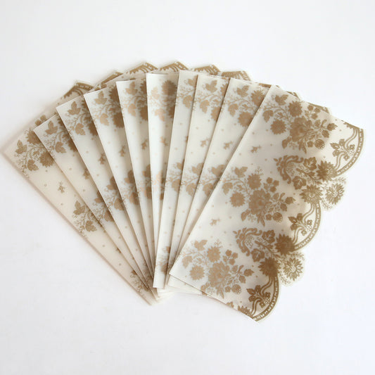 The Gold Vellum Side Wrap 10 pack features semi-transparent wraps with a gold floral pattern, perfect for wedding invitations. Shown fanned out on a white surface.