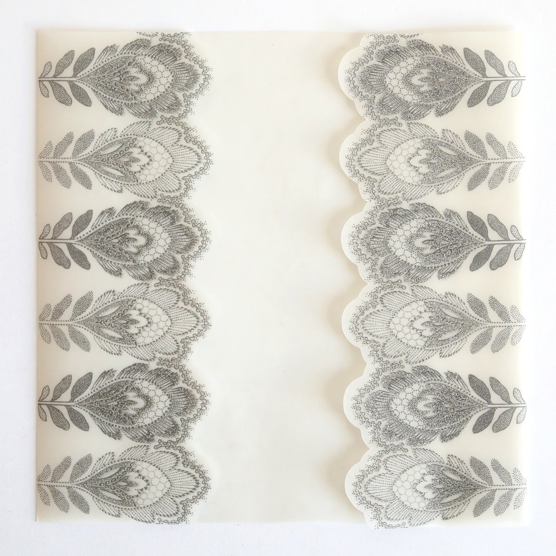 The Silver Glitter Feather Vellum Gatefold 10 pack features shimmering feather patterns and a stylish gatefold design, making it ideal for elegant wedding invitations.