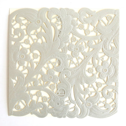 The Silver Embossed Lace Gatefold 10 pack features square, intricately cut paper with floral and swirling patterns in a pearly silver hue, perfect for elegant wedding invitations, shown laid flat on a white background.