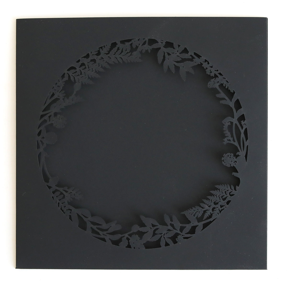 The Black Lasercut Circle Sleeve 10 pack features square black cards with intricate floral and leafy wreath cutouts—ideal as elegant invitation sleeves for weddings or special events.