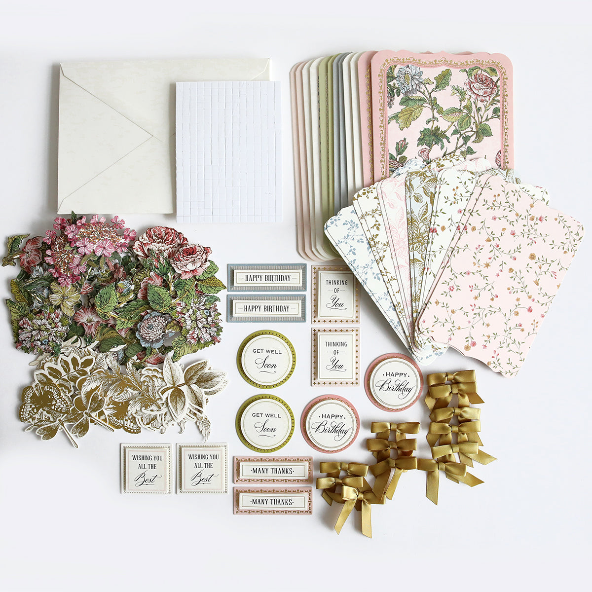 An assortment of handmade cards, including those from the Simply Wildflower Meadow Card Making Kit, and decorative stickers with 3D embellishments laid out on a white background.