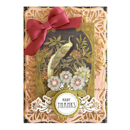 The Salon Nouveau Papercrafting Kit includes double-sided cardstock for creating thank you cards with a red bow, vintage peacock illustration, floral accents, and a “Many Thanks” message in a circular frame.