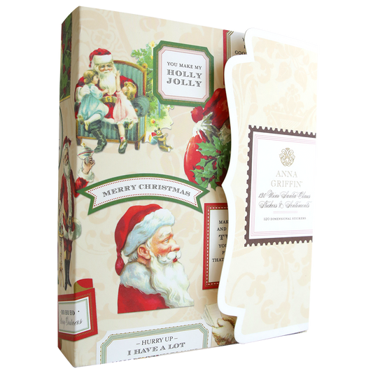 A decorative box featuring Santa & Sentiment Stickers sits next to an ornate Anna Griffin card with a printed address.