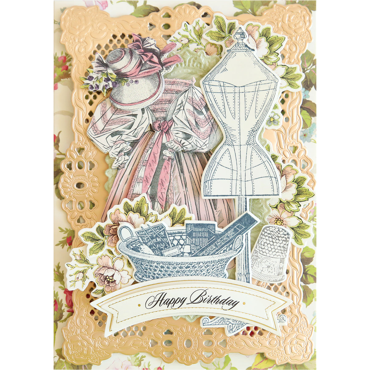 The "Sewing Stamps and Dies" birthday card showcases a timeless dress illustration, accompanied by a dress form and sewing tools nestled in a basket. A banner at the bottom elegantly displays "Happy Birthday." The design is adorned with floral and lace patterns, further enhanced by exquisite die cut tags that add a vintage charm.