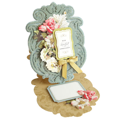 An ornate, vintage-style greeting card with floral decorations and a message that reads "With Grateful Appreciation." The card is propped open with a gold bow and additional flower motifs. Made from our Simply Appreciation Easel Card Making Kit, it's perfect for enthusiasts of handmade cards.