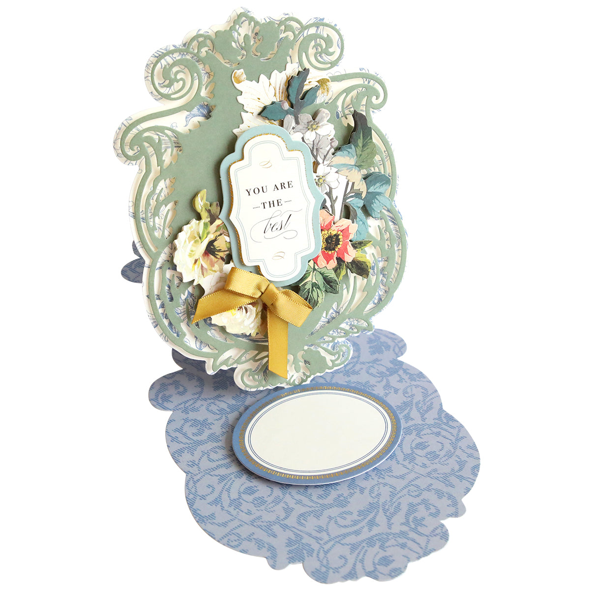 Intricately designed pop-up card with floral decorations, a ribbon, and a sign reading "You are the best," displayed on a blue patterned background. Perfect for crafters who love handmade cards featuring the Simply Appreciation Easel Card Making Kit.