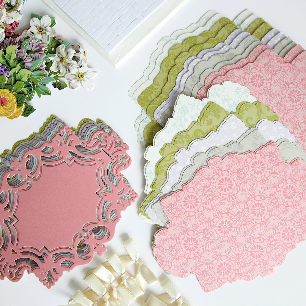 A variety of Simply Birthday Easel Card Making Kit papers and embellishments for cardmaking are laid out on a table, ready to create beautiful handmade cards.