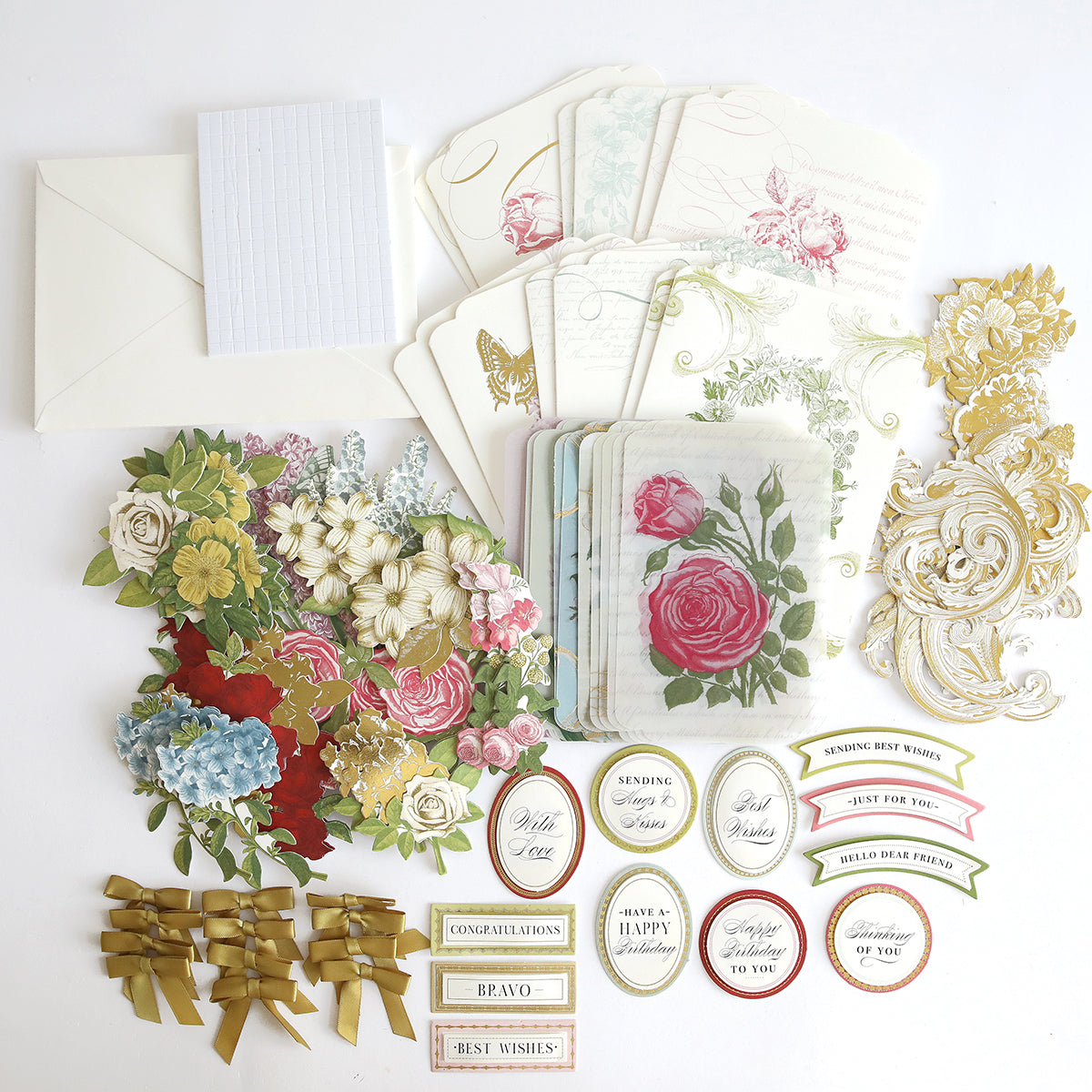 An assortment of Simply Perfect Patterns Card Making Kit including floral stickers, gold accents, decorative tags, and patterned paper on a white background.