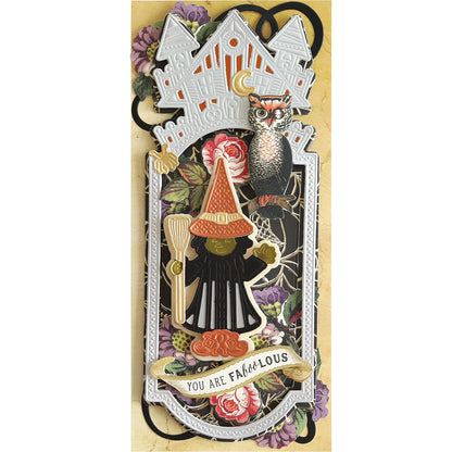 A Slimline Witch Dies card featuring a decorative Halloween theme with a witch on a broom, an owl, a haunted mansion, and the text "YOU ARE FABOOLOUS" artfully surrounded by floral elements.