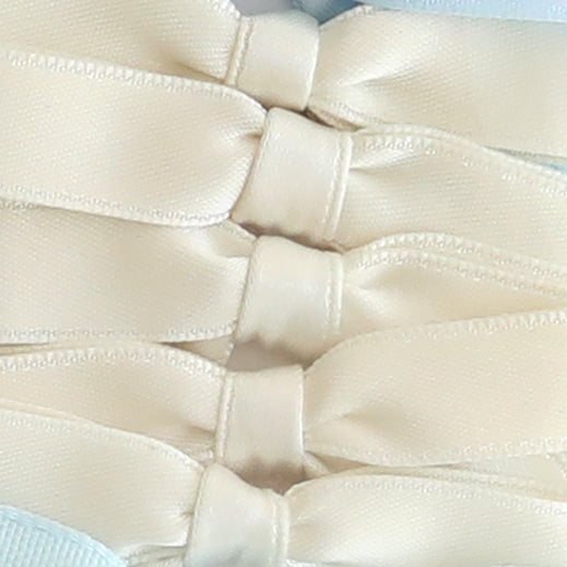 Close-up of four Small Pre-Tied Bows in ivory and gold, stacked vertically to highlight their elegant satin texture.