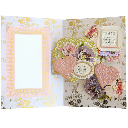 An open handmade greeting card featuring floral designs and embellishments with a "thank you" note and blank space for a personal message created using Swing Out Dies.