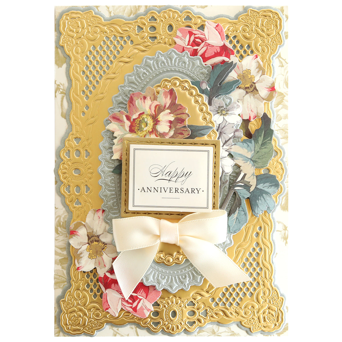 An ornate anniversary card with floral designs, a central ribbon bow, and embossed golden borders, featuring the text "Happy Anniversary" and additional embellishments created using Swing Out Dies.