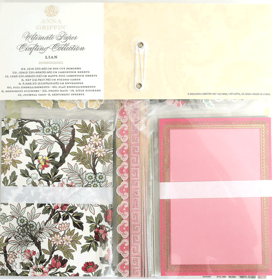 The Fanmail Friday Lian Paper Dress Bundle features decorative floral and pink patterned cardstock, card borders, and coordinating embellishments, all packaged in clear plastic.