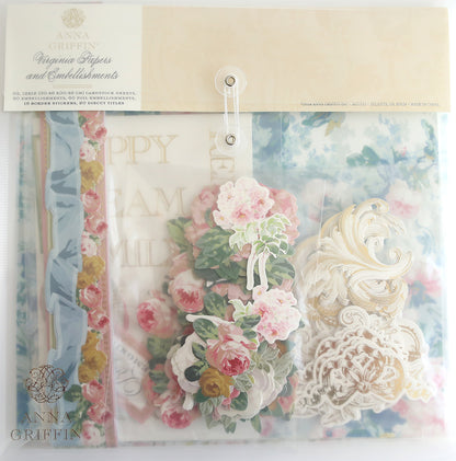 A package labeled "Virginia Papers and Embellishments" containing various decorative scrapbook papers and craft embellishments, including floral and ornate designs. The items are partially visible through the clear packaging.