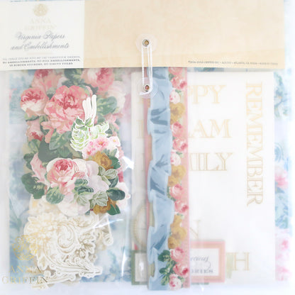 The Crop at Home 4 Scrapbook Collection includes a package of floral-themed craft papers and embellishments with decorative text, featuring die-cut titles like "Happy" and "Remember," making it perfect for your next Crop at Home event.